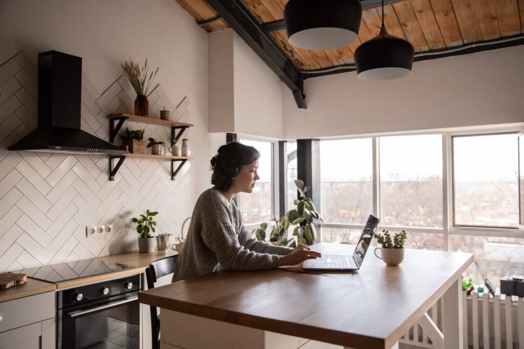 Woman writing on a computer in the kitchen